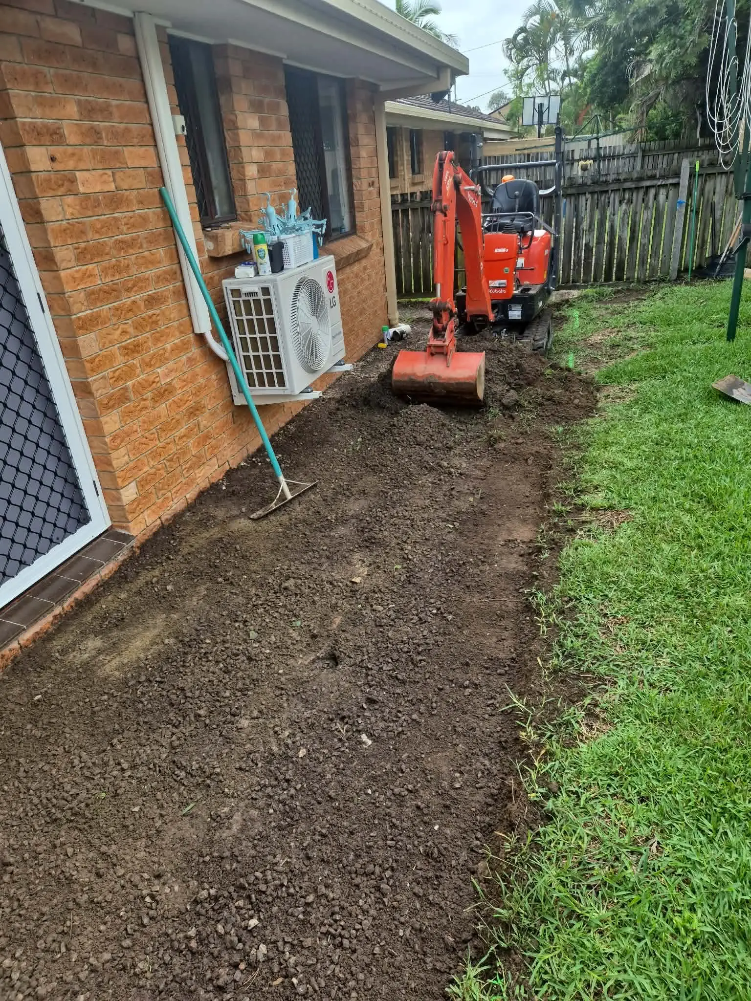 Drainage trench excavation alongside house Brisbane